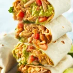 Homemade chicken burrito filled with shredded chicken, rice, and cheese.